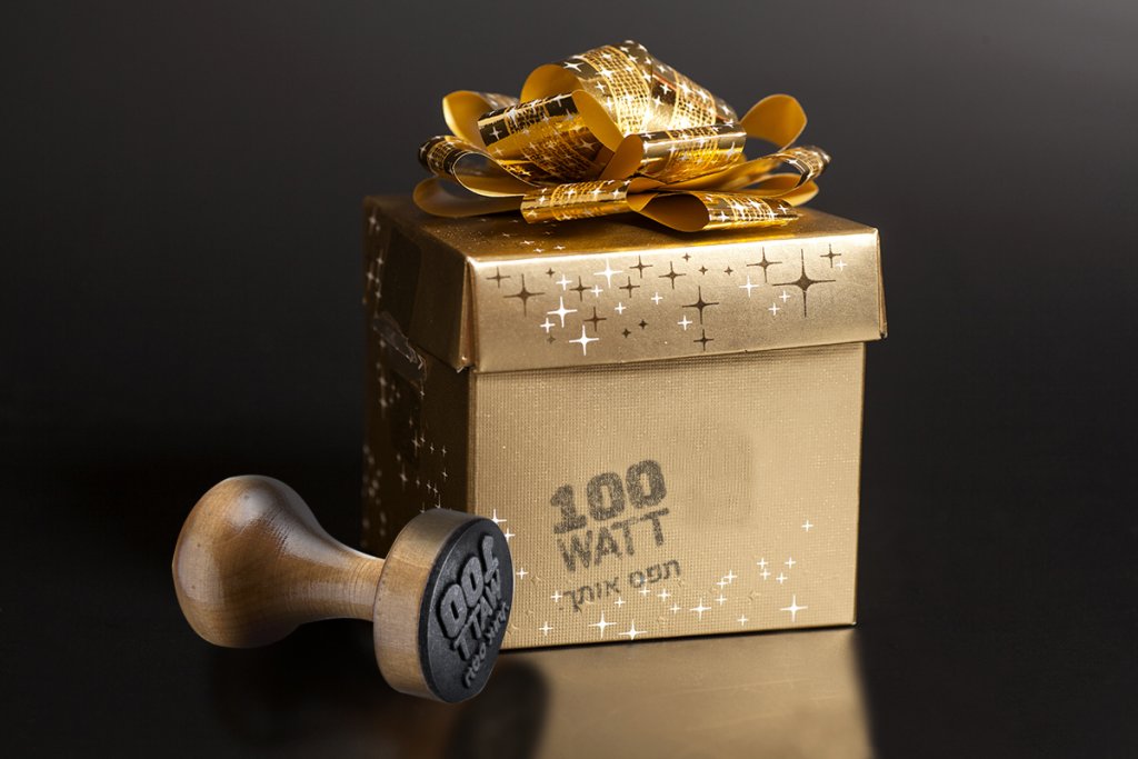 Golden gift box with golden ribbon on black background