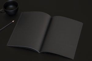 Dark notebook on black background.